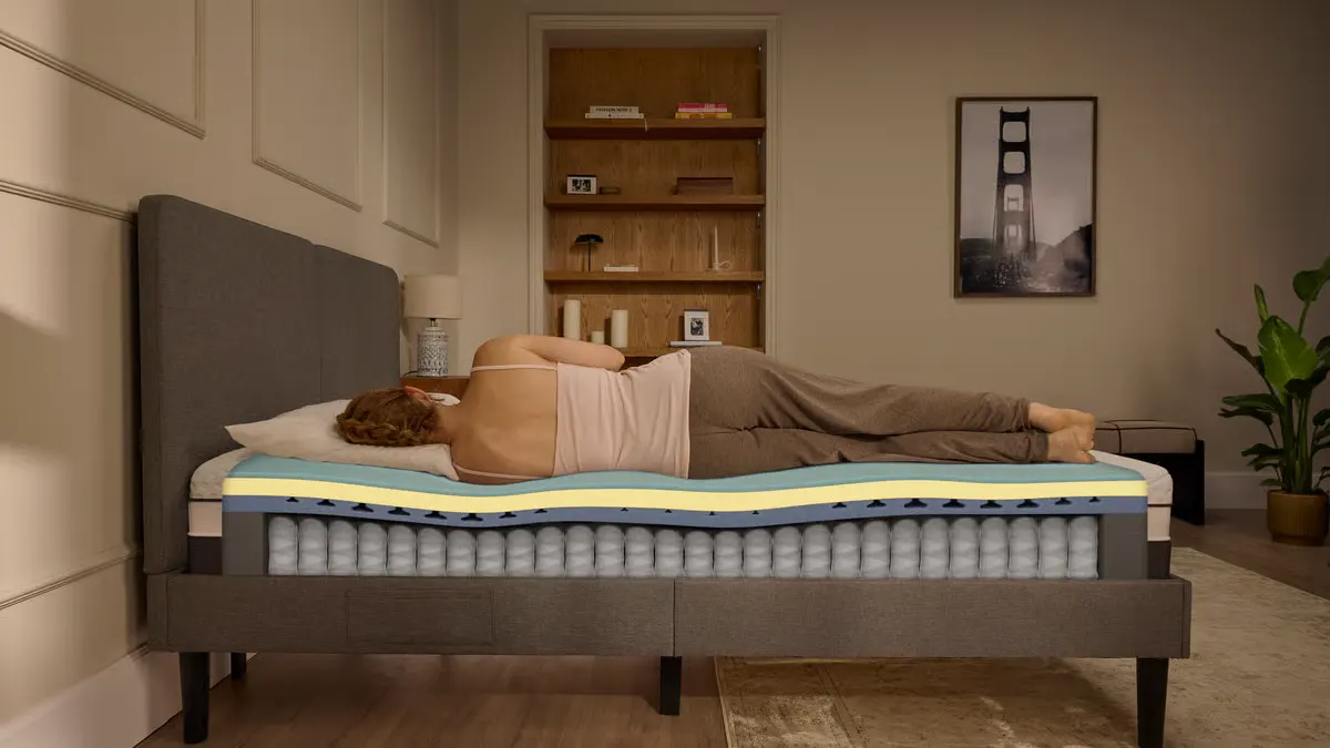 Cutaway view of the Emma Luxe ViscoCool with a side sleeper on top, showing the foam comfort layers stacked over a pocket spring base.